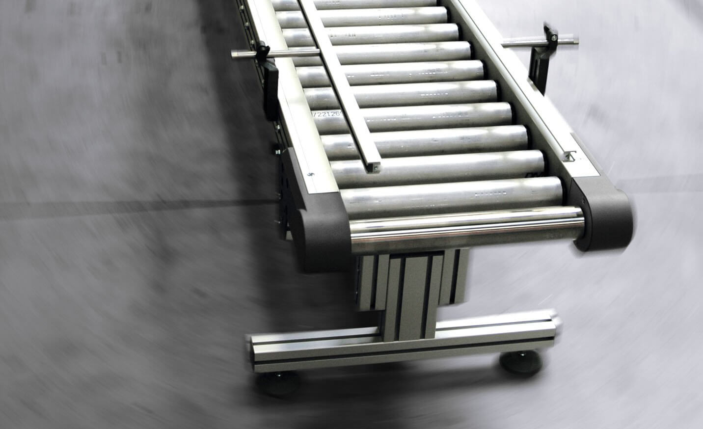 Roller conveyor system, driven roller conveyor with lateral guide